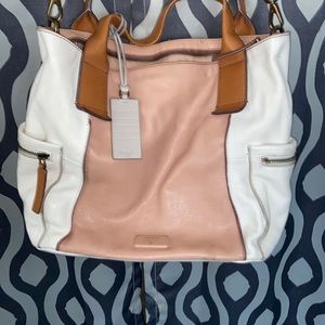 large fossil purse with a detachable strap.